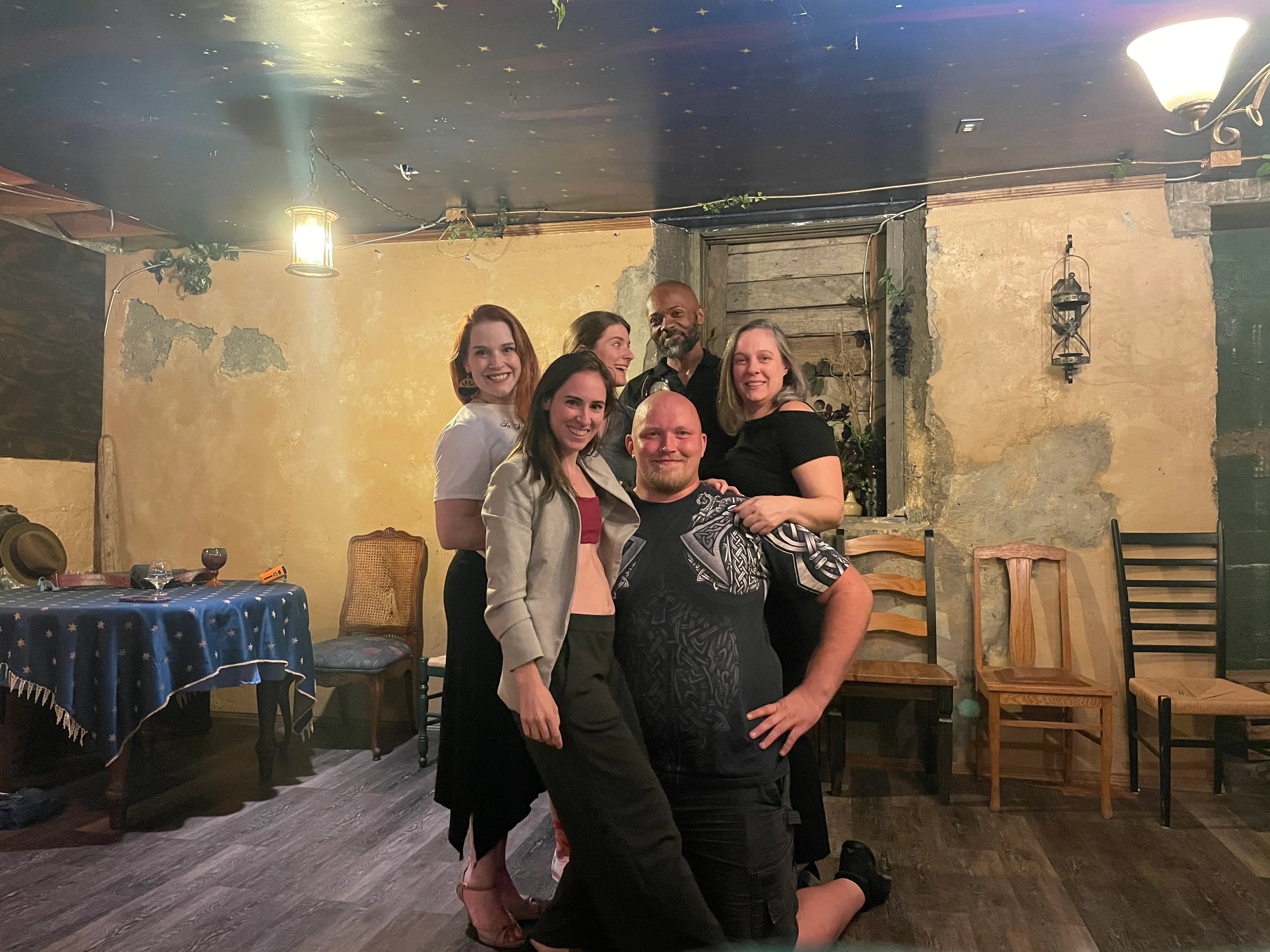 Six members of the tango community posing for a group photo.